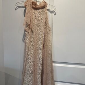 Elegant tan and cream lace dress with chiffon overlay and bow neckline.